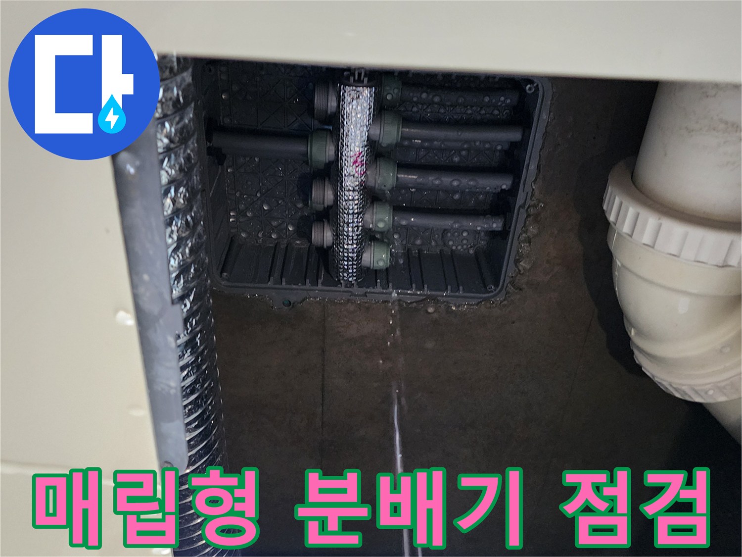 주방 싱크대 아래 설치된 스테인리스 분배기와 배관 연결 부위