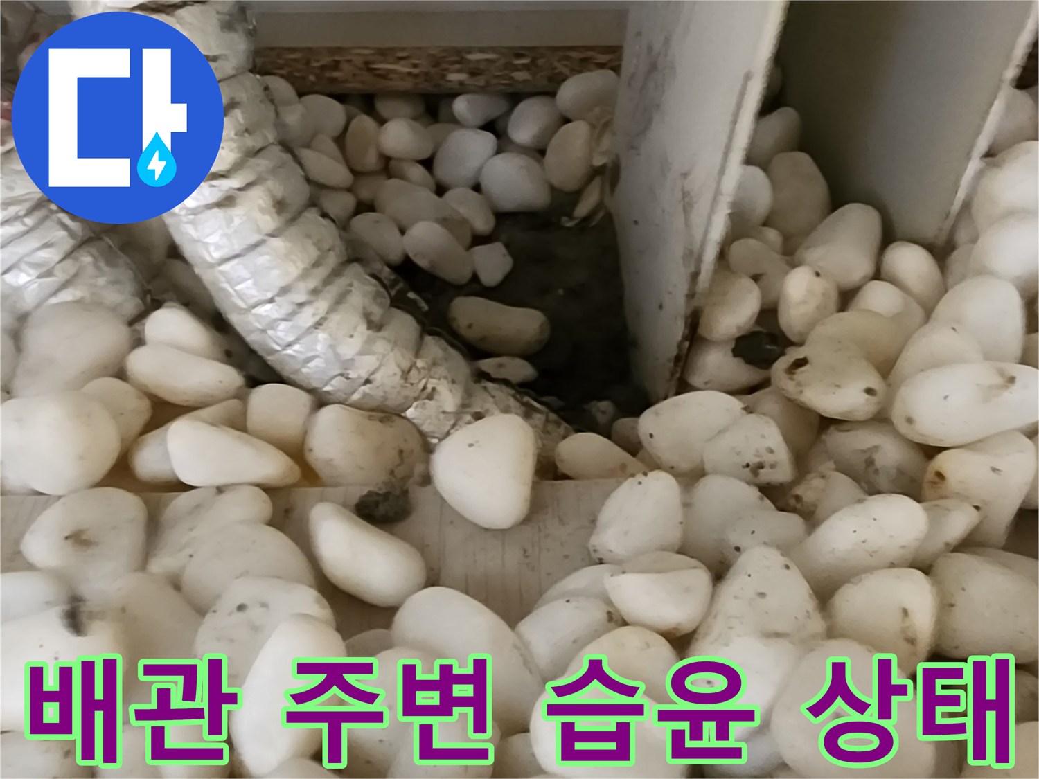 배관 보온재와 젖은 자갈이 섞여 있는 사진입니다.