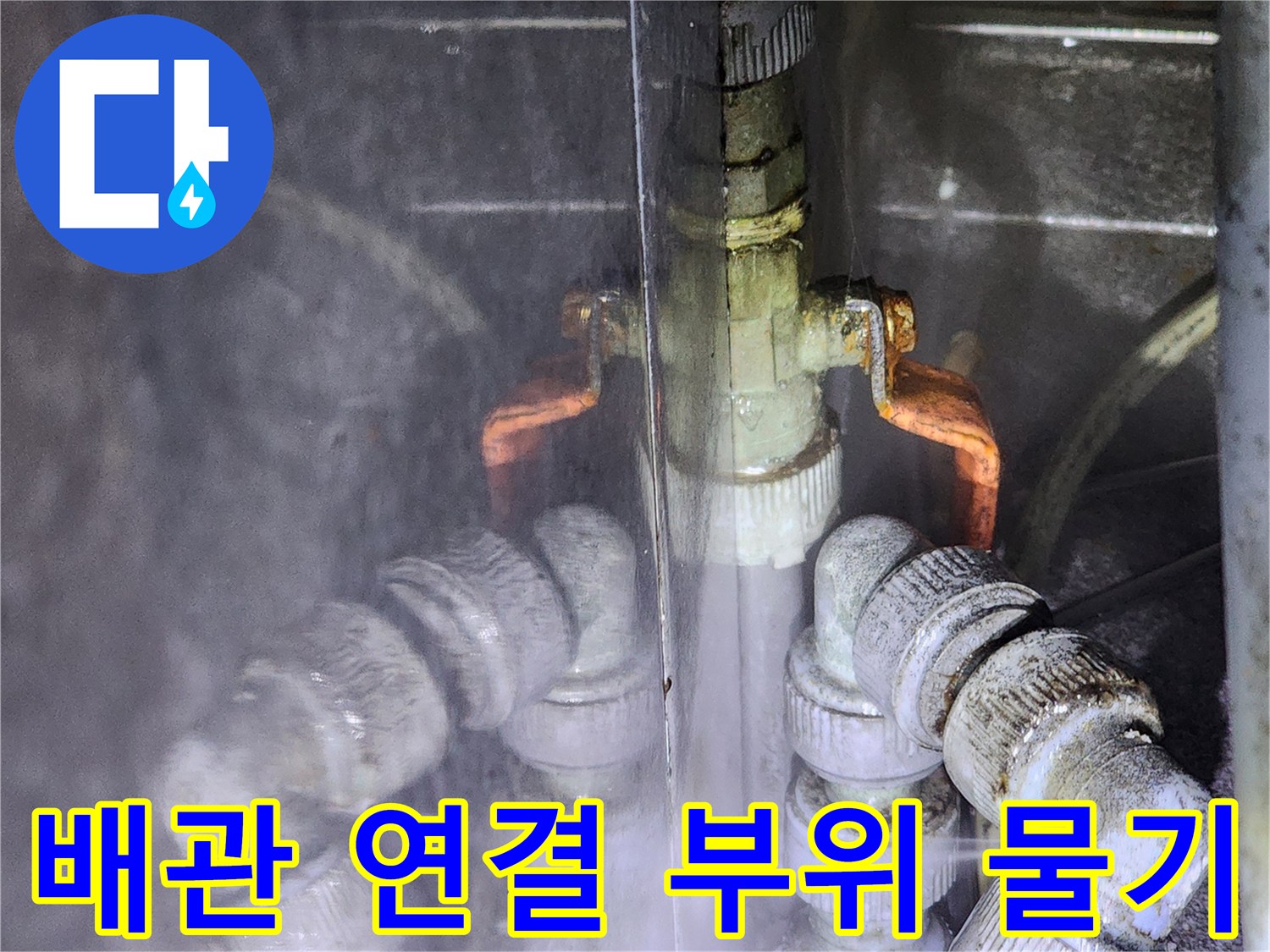 배관 엘보와 금속 밸브 사이의 습기와 물기를 보여주는 근접 사진입니다.