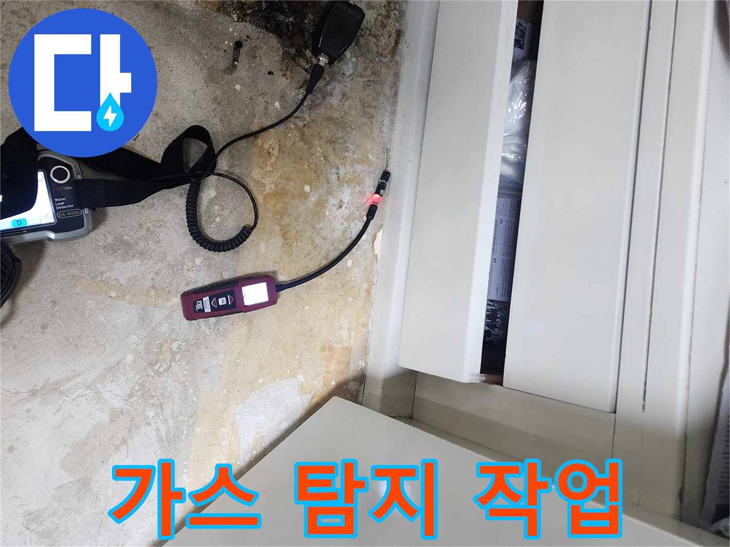 바닥의 젖은 부위와 연결된 누수 탐지용 센서 장비