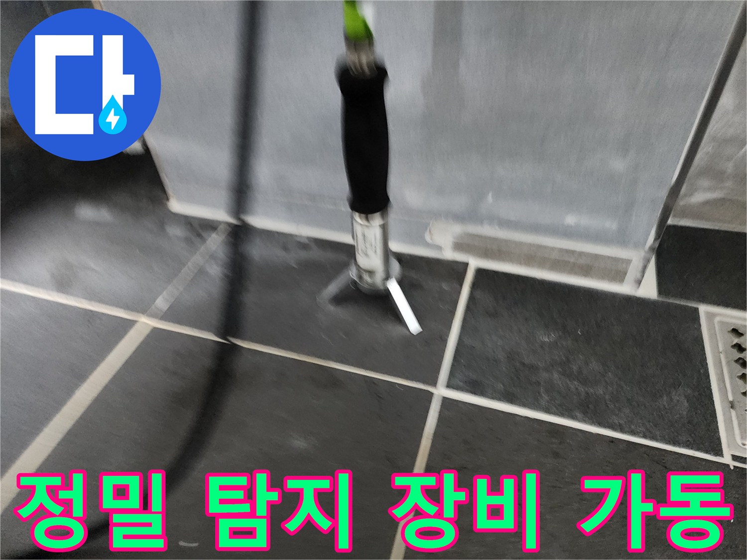 욕실 바닥 누수 지점을 찾기 위해 정밀 탐지기를 사용하는 모습