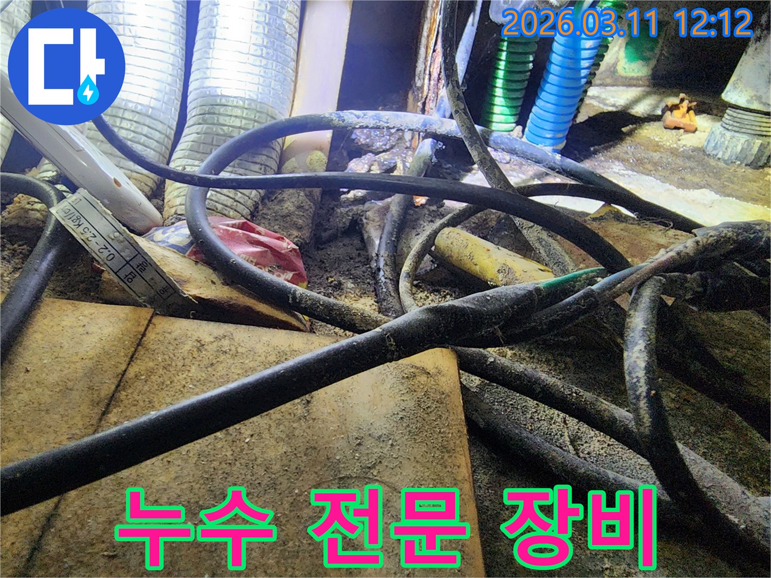 누수-현장에서-복잡하게-얽힌-배관과-전선-사이의-오염된-환경을-보여주는-사진입니다.