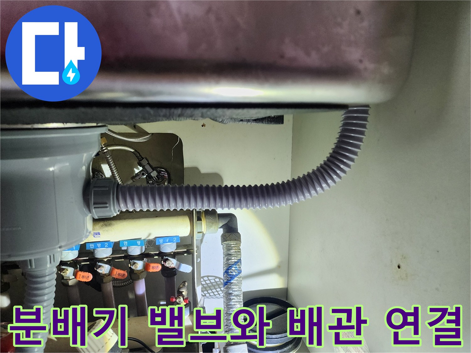 보일러 분배기 밸브의 부식 상태와 연결된 회색 주름관 모습