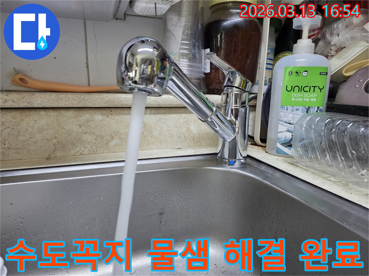 새로 교체된 싱크대 수도꼭지에서 물줄기가 깨끗하게 뿜어져 나오는 모습-주방의 위생과 사용 편의성을 높였습니다