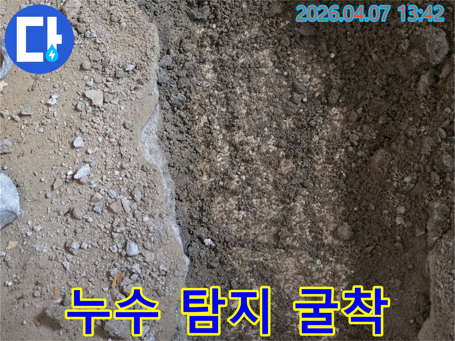 누수-현장에서-땅을-파내어-젖은-흙과-배관이-드러난-모습을-담은-사진