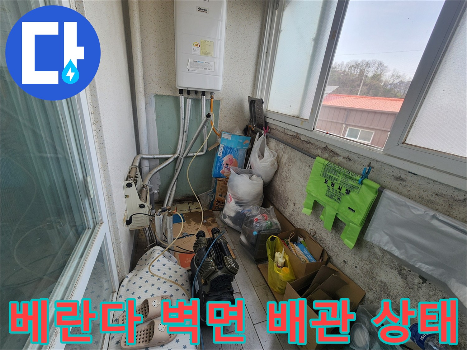 아파트 베란다 배관 - 보일러 하단에 노출된 배관과 주변 환경의 모습입니다.
