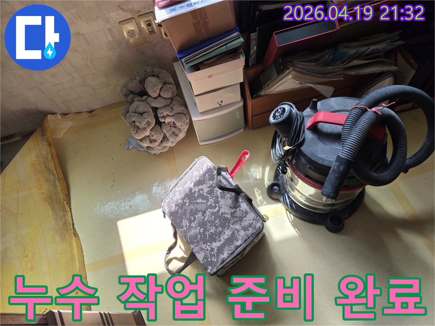 누수 현장에서-필수 장비인-습식 청소기와-공구 가방이-정돈된 장면
