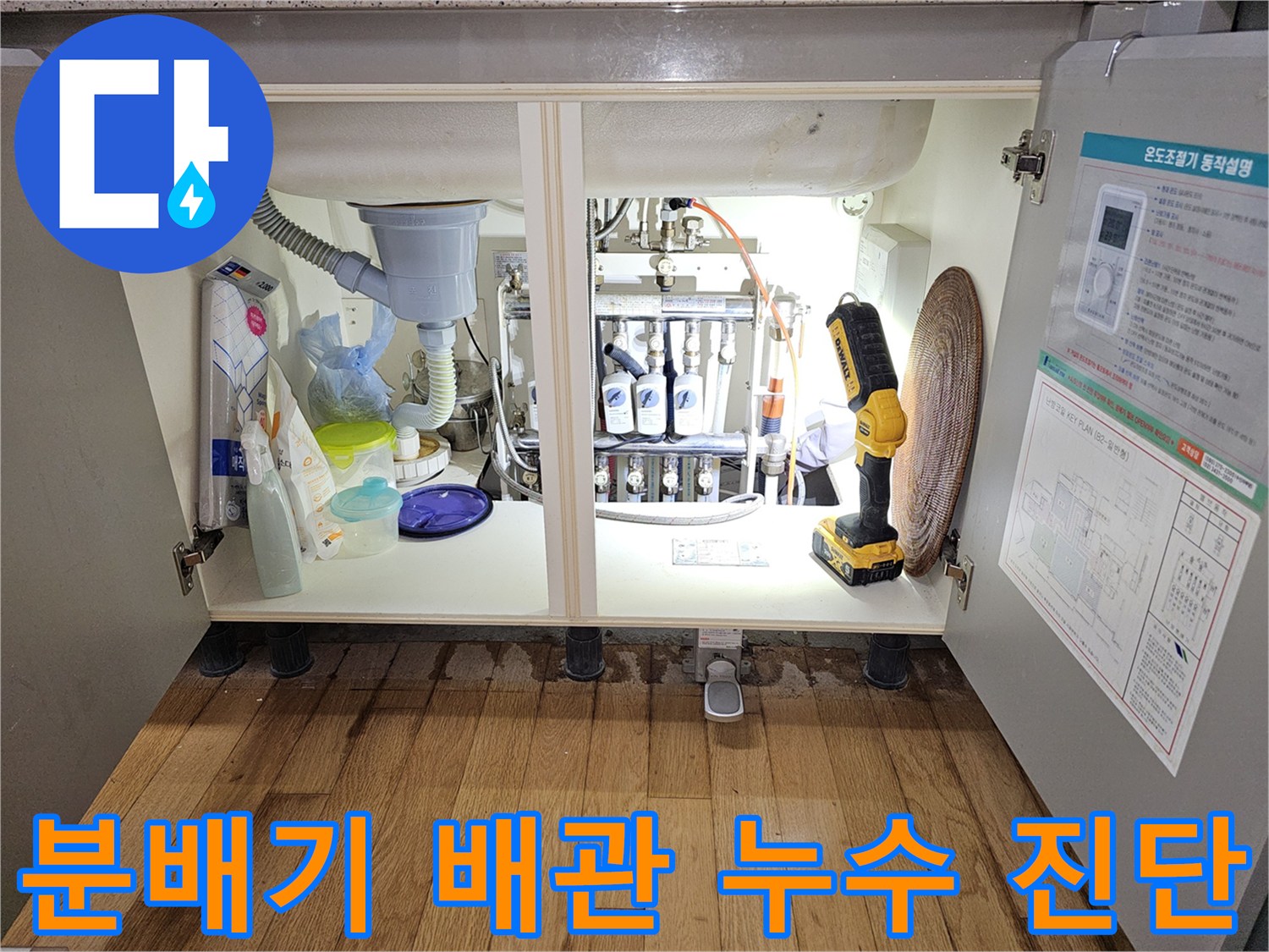 싱크대 하부장 내부에 보이는 분배기 밸브와 연결된 배관들