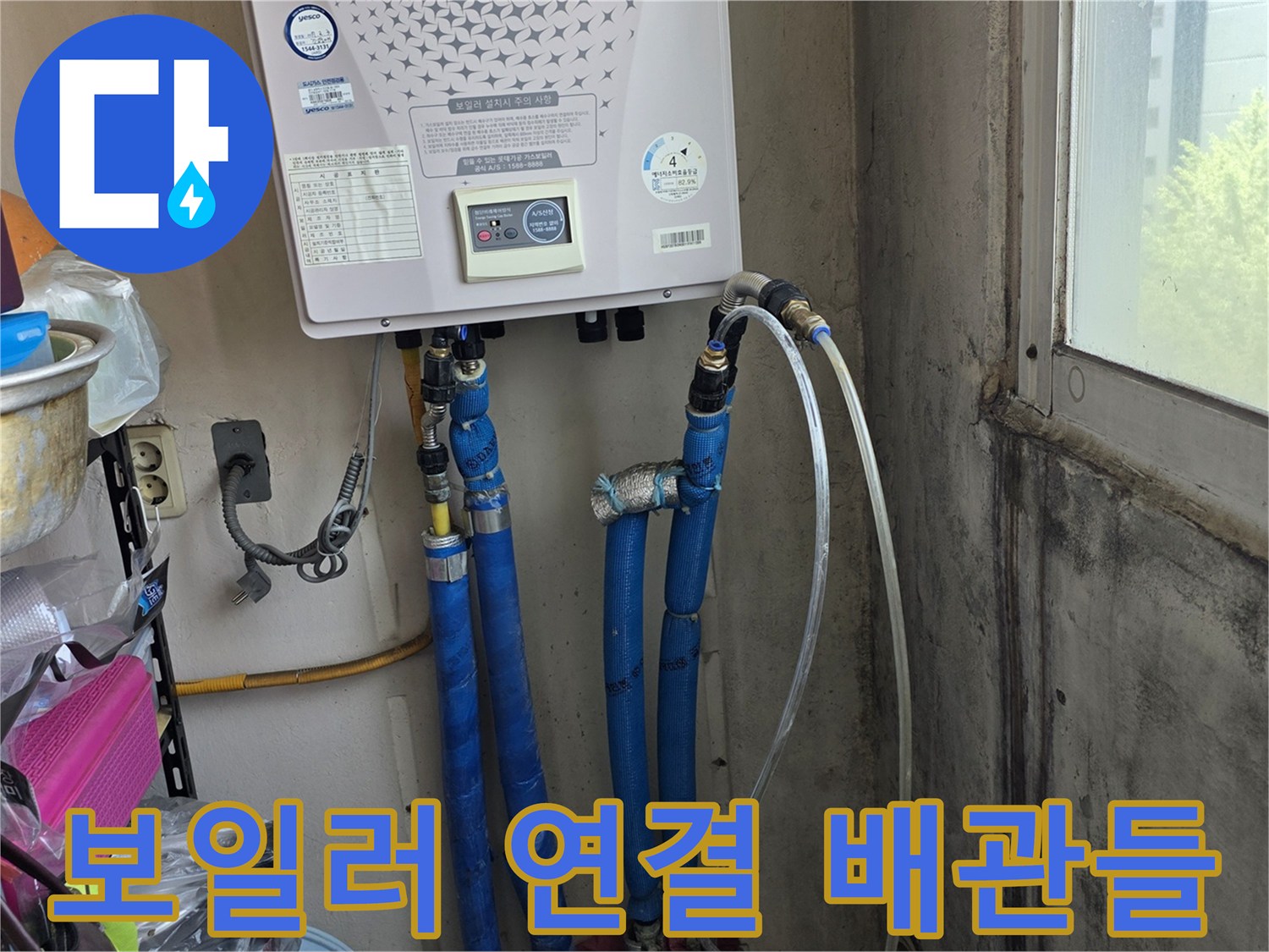 보일러 하단부-연결된 파란색 배관과 급수 부속의 근접 촬영