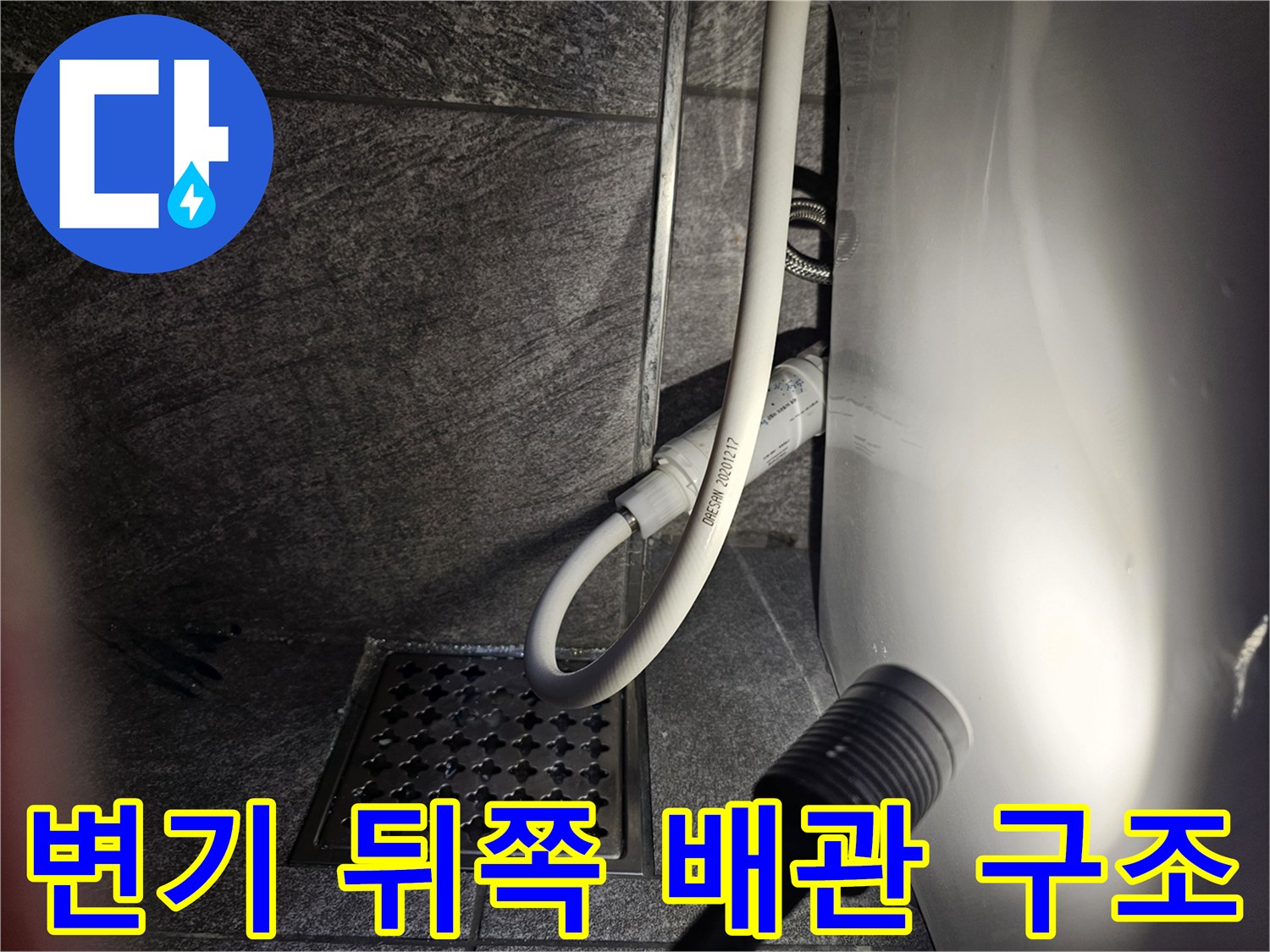 탈거된 변기 자리의 하수구와 급수 호스 연결 상태