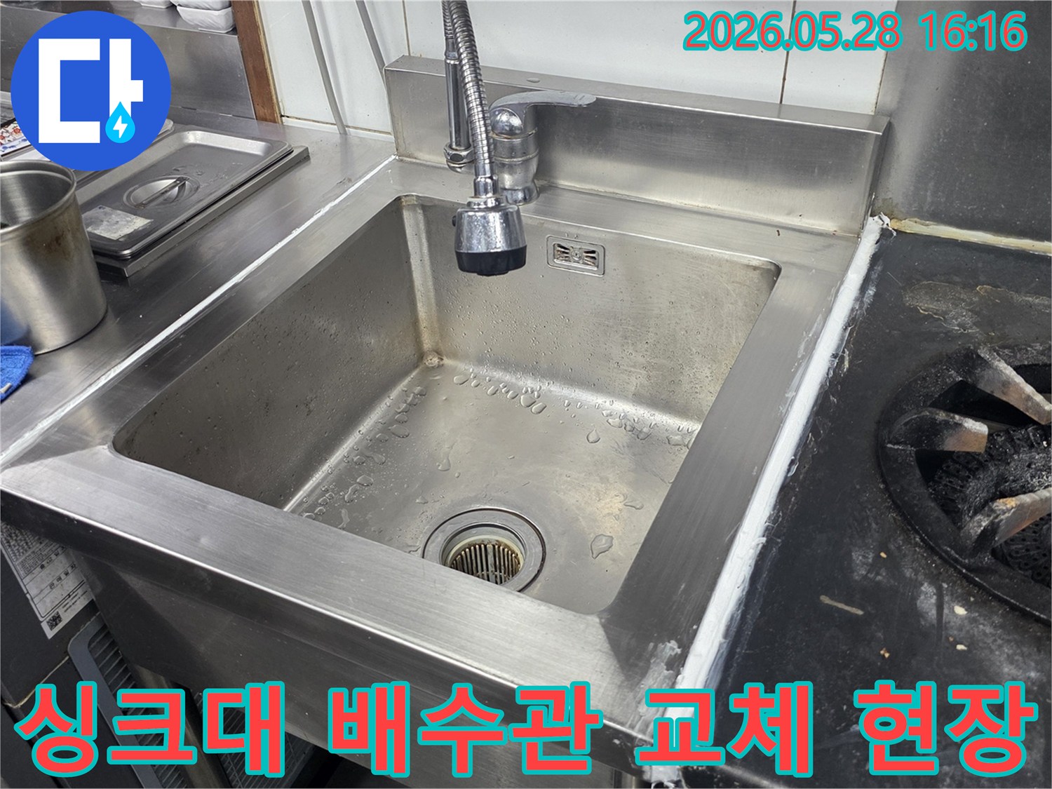 스테인리스-싱크대-하부의-손상된-배수관을-새로운-배관으로-교체하는-전문-기술자의-작업-모습을-담은-사진