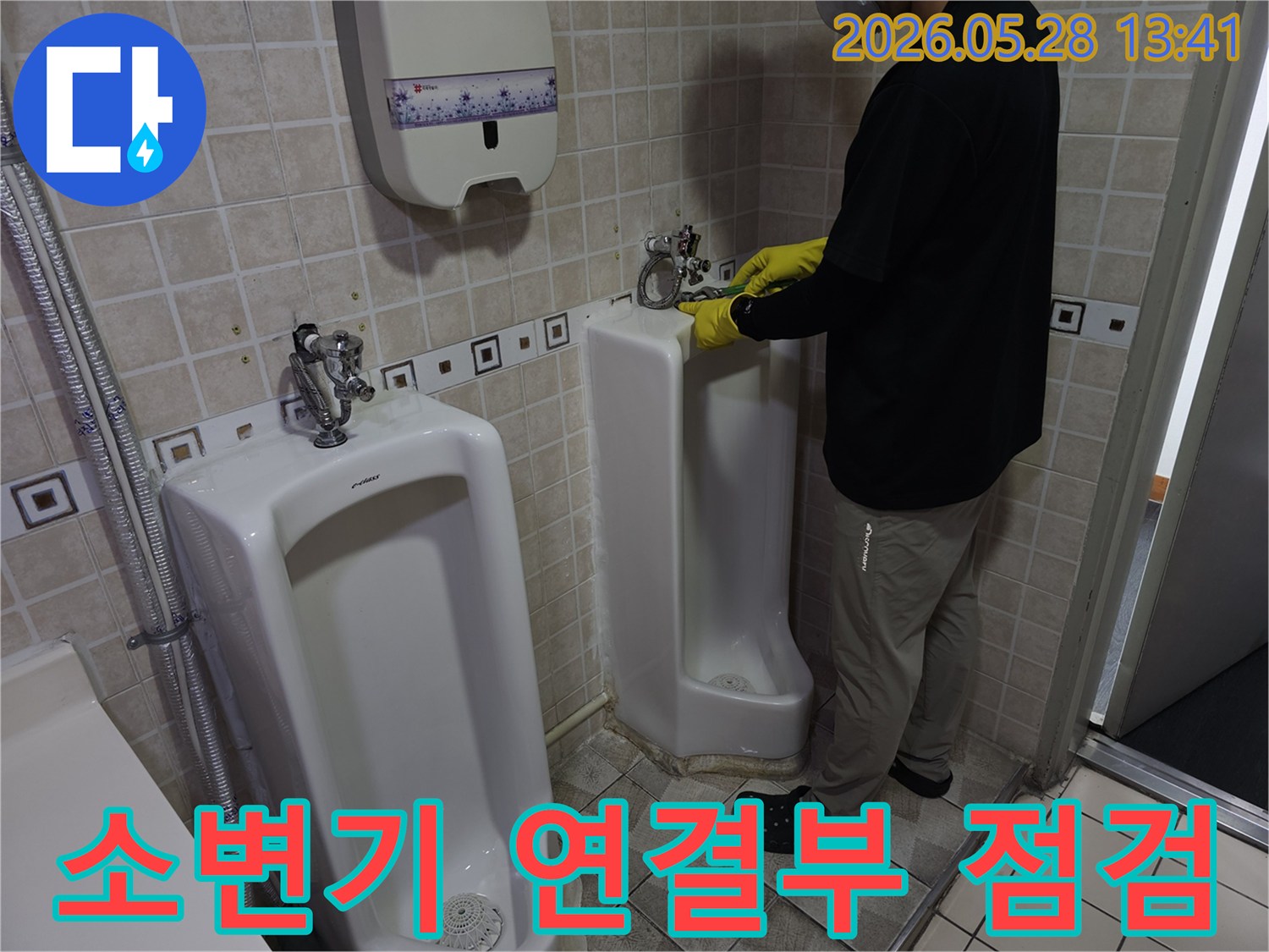 누수 전문 엔지니어가-소변기 연결 부위의-누수 여부를-세심하게 점검하고 있습니다