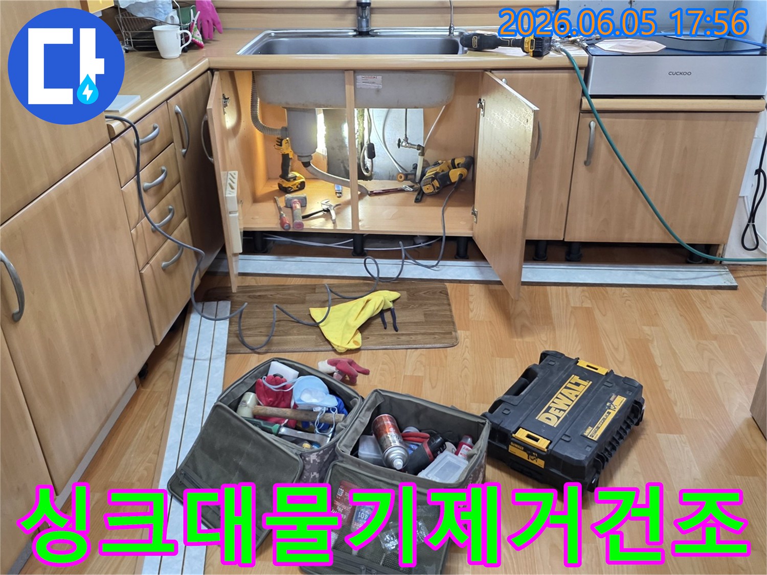싱크대 하부장 내부의-물기 제거 및 건조 작업을 위해-전문 공구들이-준비된 작업 현장입니다.