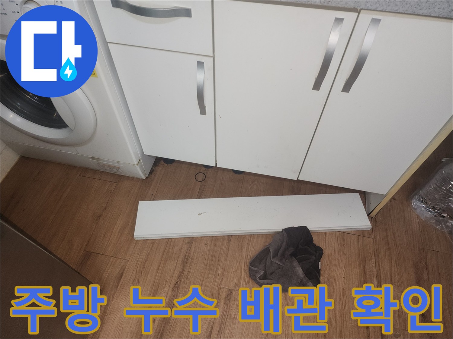 주방-누수-조사를-위해-싱크대-하부-걸레받이를-제거하고-내부-배관-상태를-점검하는-사진입니다