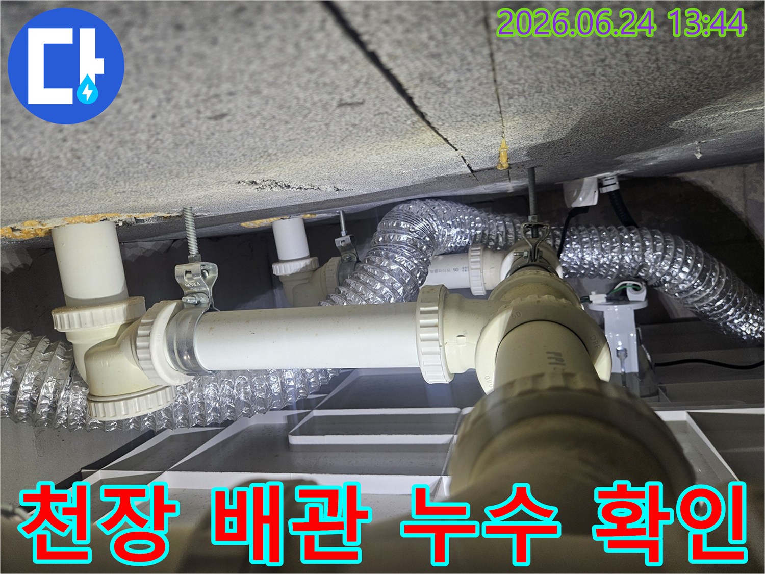 천장 속 다양한 배관과-환기 시설이-누수 점검을 위해-조명 아래 드러난 현장 사진입니다