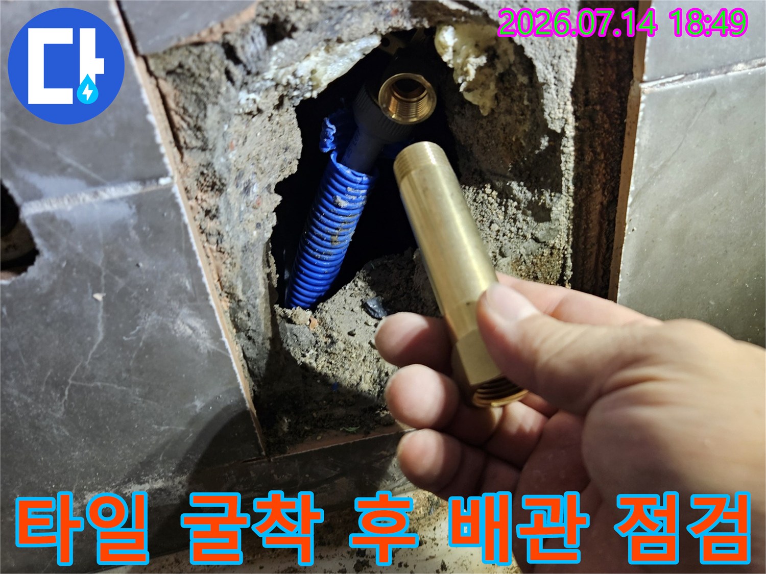 파색의 보호막으로 감싸진 파란색 매립 배관과 수전 연결부를 세밀하게 확인하는 장면