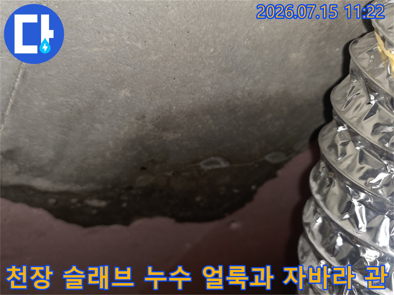 은색 주름 배관 옆으로 검게 오염된 천장 콘크리트 면이 드러난 사진