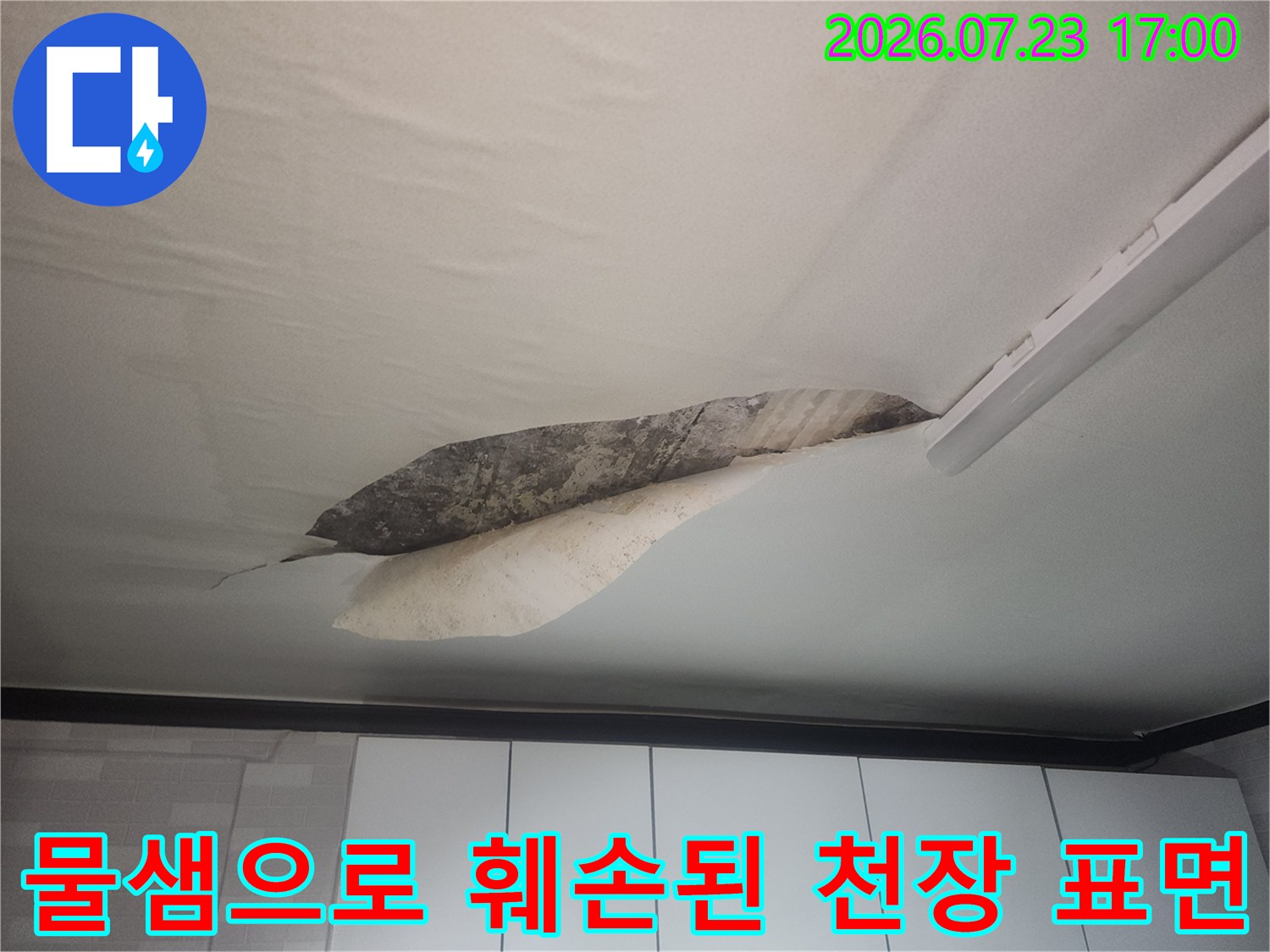 거실 천장 마감재가 누수로 인해 젖어 들뜨고 곰팡이가 발생한 모습