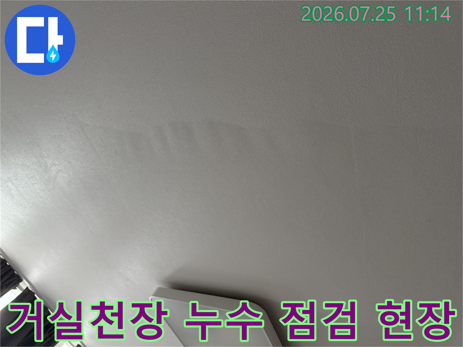 거실 천장 마감재 위로 배어 나온 물자국과 변색 흔적