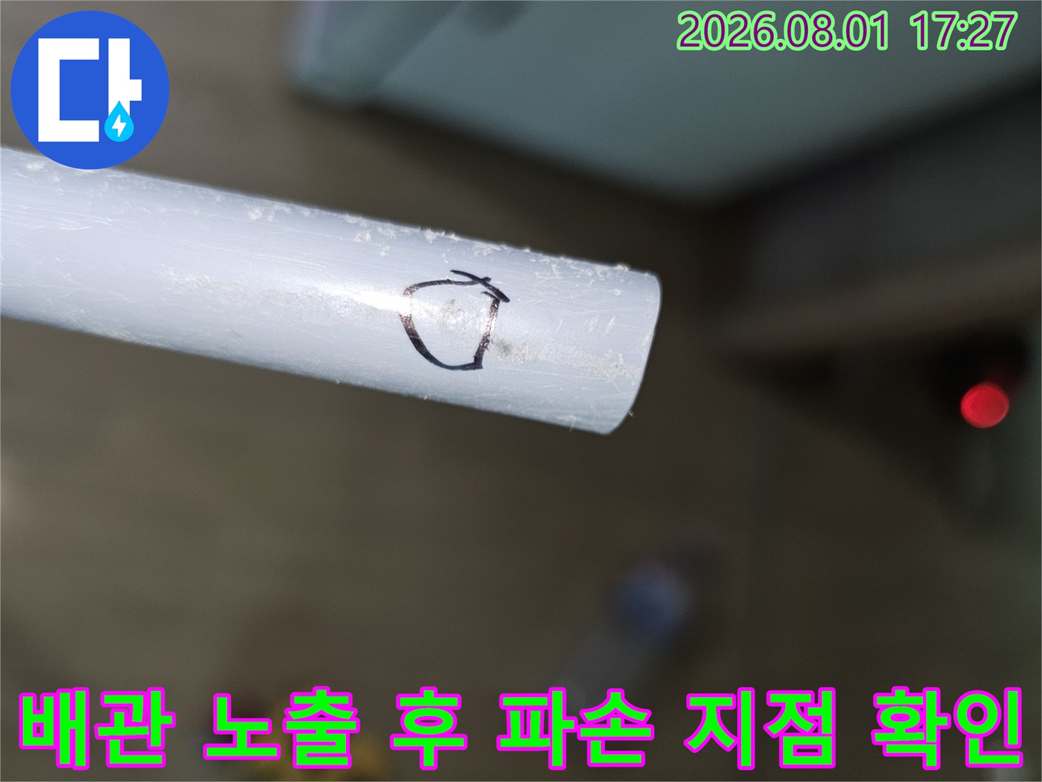 흰색 배관의 손상 부위를 면밀히 조사하고 있는 현장 모습