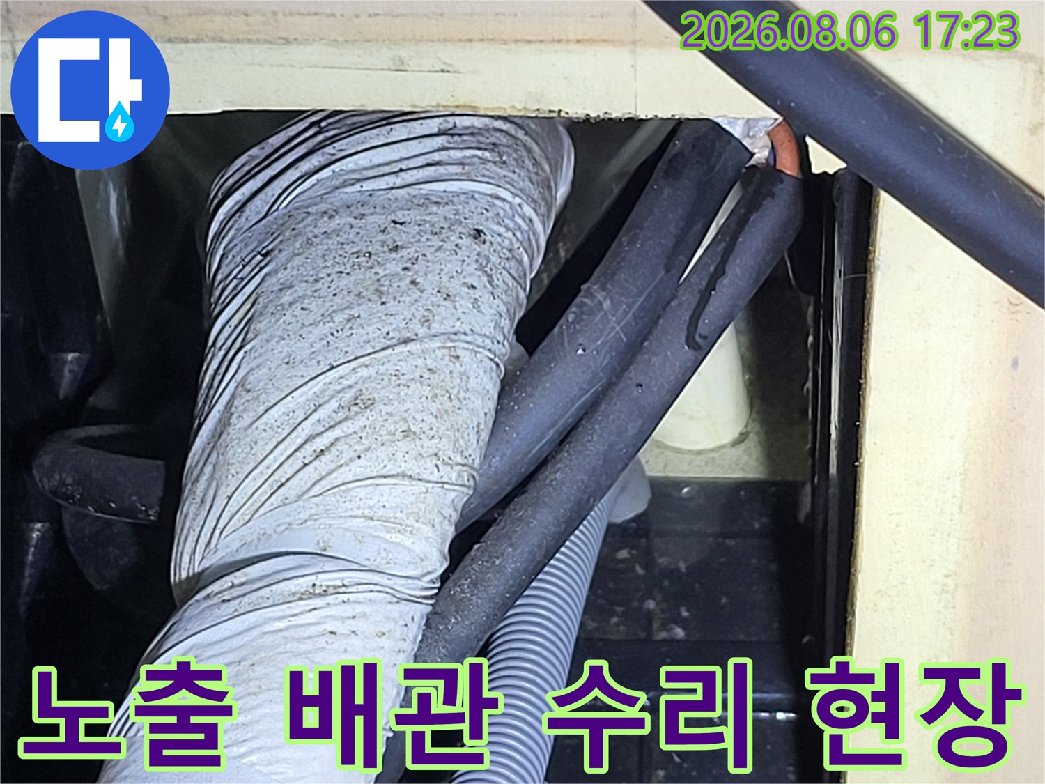 보호재로 감싸진 노출 배관과 공사용 호스들