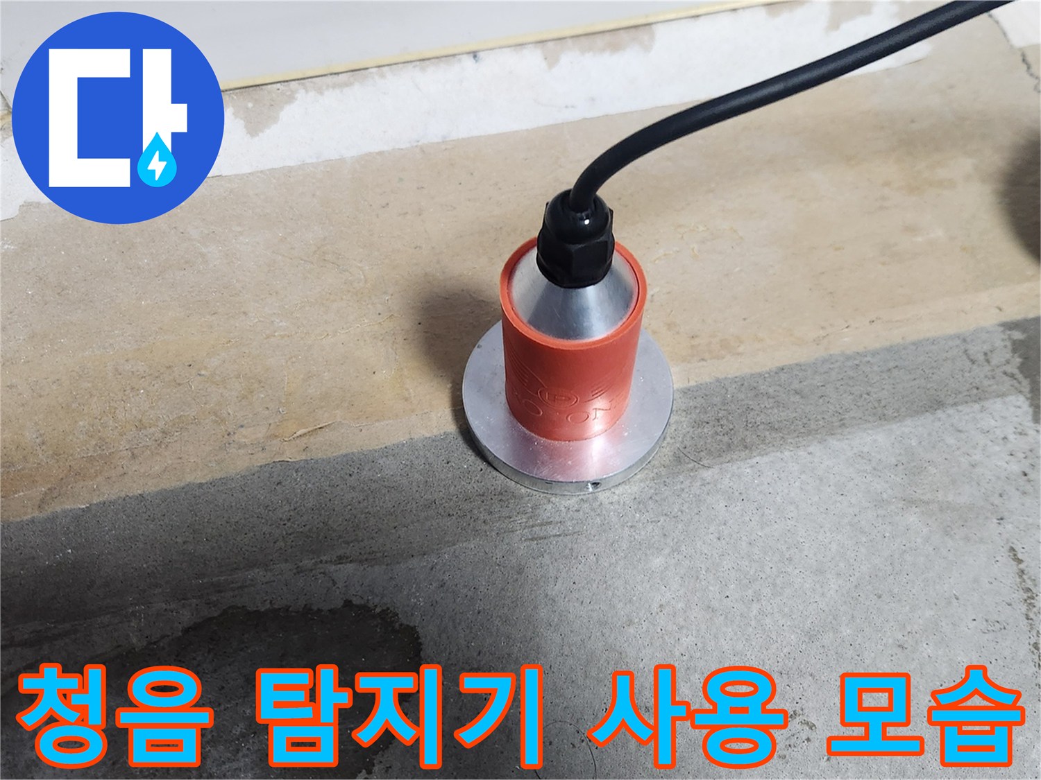 가스 배관 누출 지점을 찾기 위해 청음 탐지기를 바닥에 대고 있는 장면